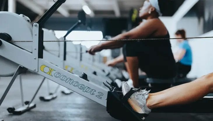 Members pulling on row machine
